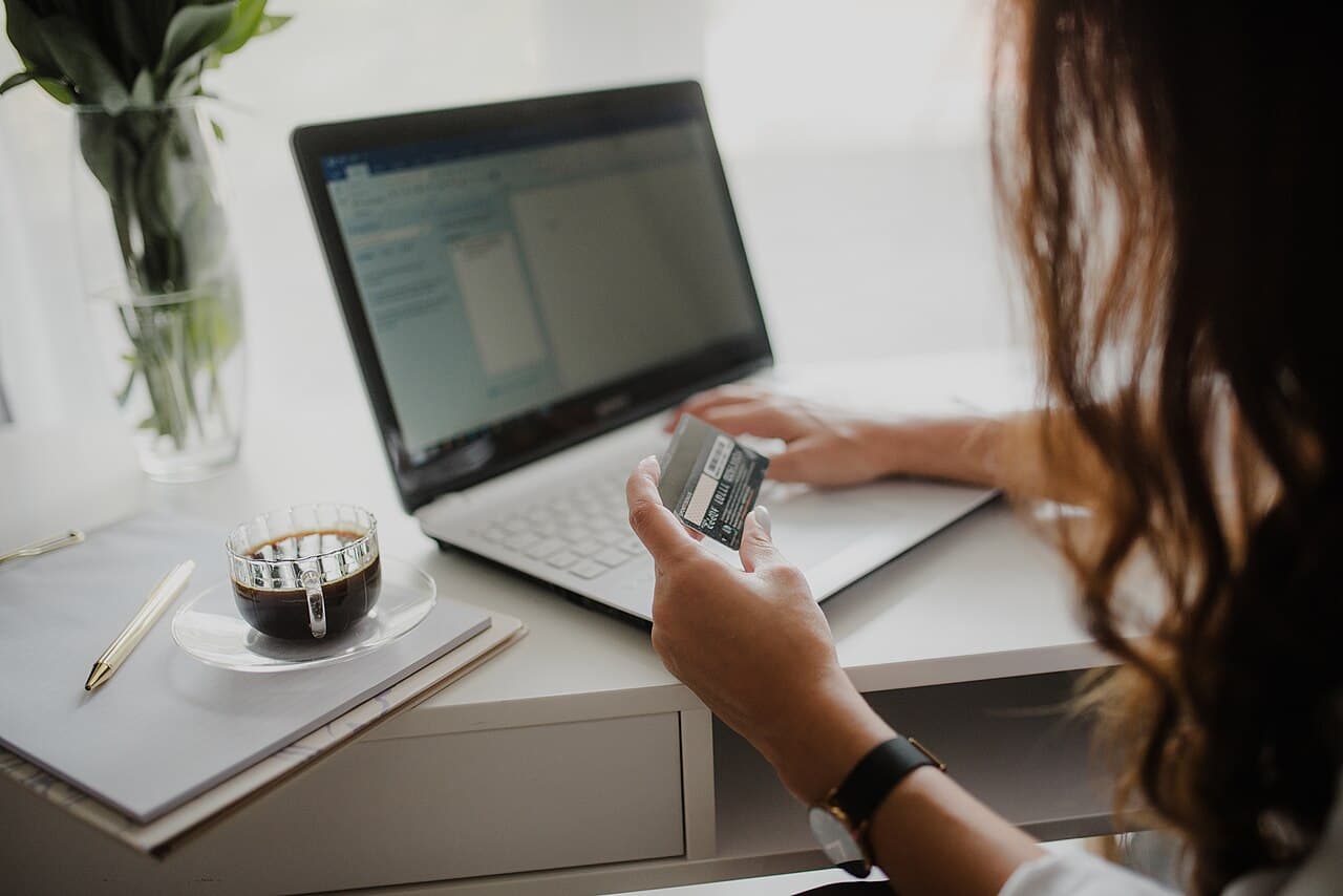 A person checking a video on a laptop while researching — verifying a crowdfunding prototype demo before backing